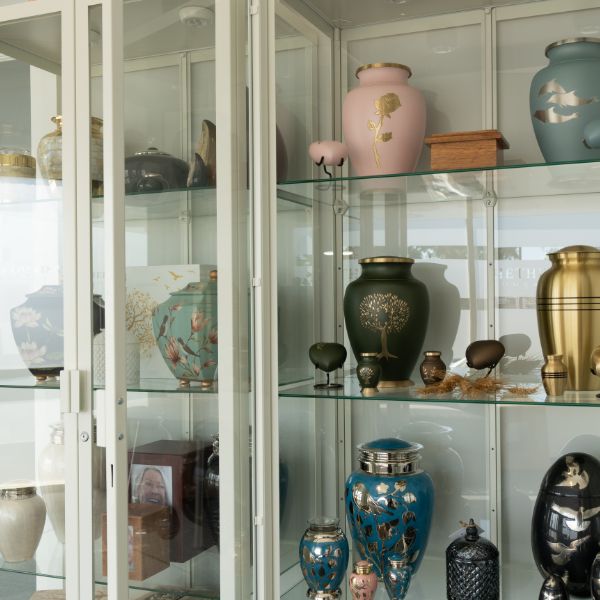 two cabinets with urns